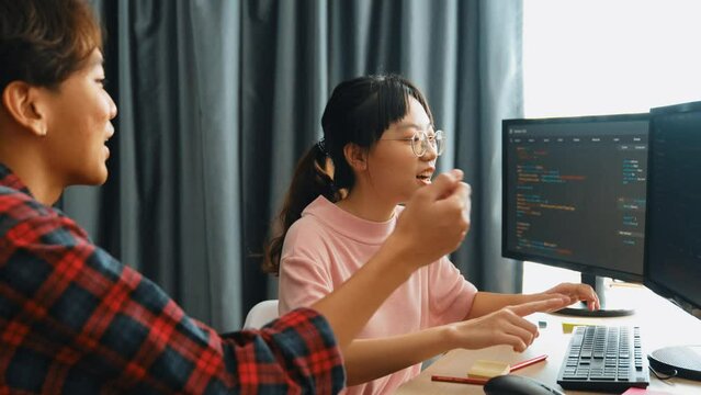 Slow motion back end software developer engineer for computer programming working together on debugging writing computing code, solving complex algorithms display on monitor in office. Burgeoning