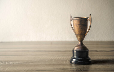 vintage champion golden trophy placed on wooden table