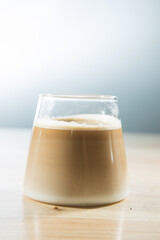 hot latte coffee in glass on wood table - vintage effect style pictures