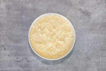 Top view of chick pea flour in a white bowl.