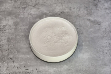 Cassava flour made from the whole root of the cassava plant in a white bowl.