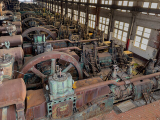 Interior image of the long factory floor with the heavy equipment and machinery used in the early...