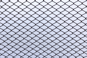 chain-link fence, fence made of wire in diamond shapes on a white background