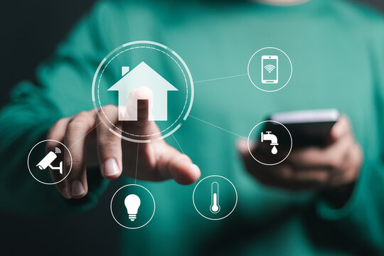 Smart home control concept. remote home control online home automation system. Person use smartphone with smart home icon on virtual screen.
