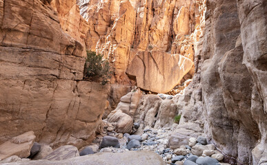 Huge stone in middle of tourist route of gorge Wadi Al Ghuwayr or An Nakhil and the wadi Al Dathneh near Amman in Jordan