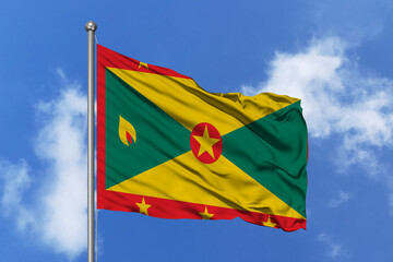 Grenada flag fluttering in the wind on sky.