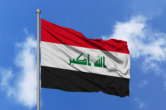 Iraq flag fluttering in the wind on sky.