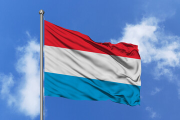 Luxembourg flag fluttering in the wind on sky.