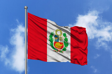 Peru flag fluttering in the wind on sky.