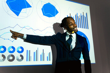 Black businessman giving a presentation using a projector
