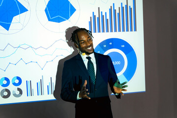 Black businessman giving a presentation using a projector