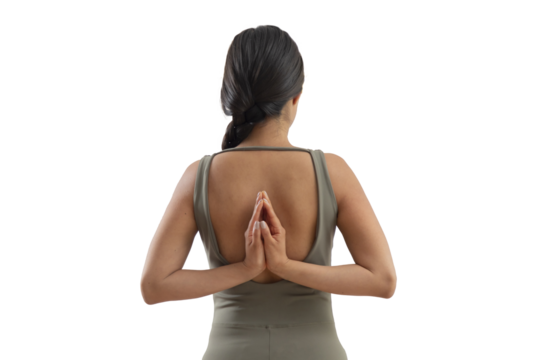 Young mexican woman with palms together behind her back doing namaste gesture
