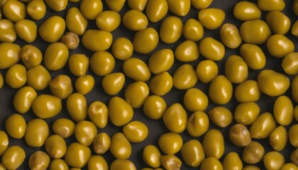  A close-up of shiny, round, yellow-green olives