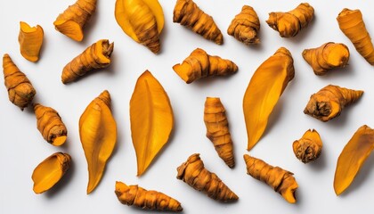  A collection of fresh ginger root slices on a white background