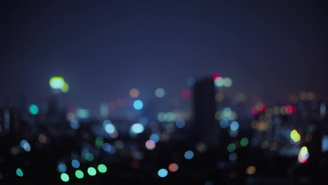 Blurred of night city skyscraper and tower lights bokeh , Soft Focus , Metropolis Backgound wallpaper for movie or documentary romantic mood concept