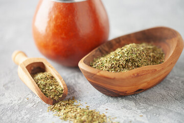 Healthy infused drink, classic Yerba Mate tea in calabash with bombilla on grey background