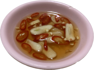 Garlic and red chili fish sauce in small pink cups placed on isolated background, sauce for thai rice street food 