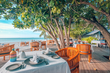 Outdoor restaurant beach bar. Luxury table setting tropical beach restaurant. Sunset light trees wooden tables chairs under beautiful romantic vintage sky, sea view. Cozy hotel resort tourism travel