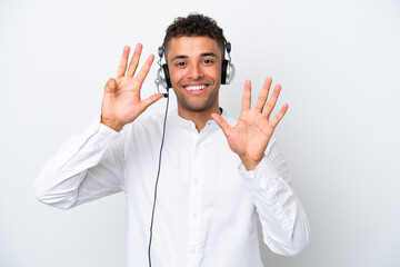 Telemarketer Brazilian man working with a headset isolated on white background counting nine with...