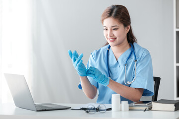 Young hispanic woman wearing doctor uniform wearing gloves at clinic