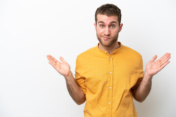 Young caucasian man isolated on white background having doubts while raising hands