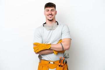 Young caucasian electrician man isolated on white background keeping the arms crossed in frontal...