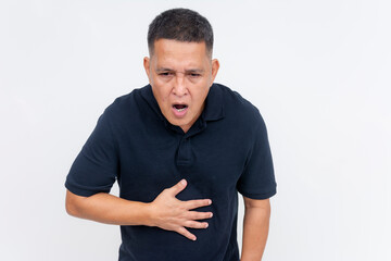 Fototapeta premium A middle-aged man appears nauseated, hand on stomach, looking like he might vomit, against a clean white background.