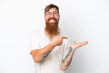 Redhead man with long beard isolated on white background holding copyspace imaginary on the palm to...