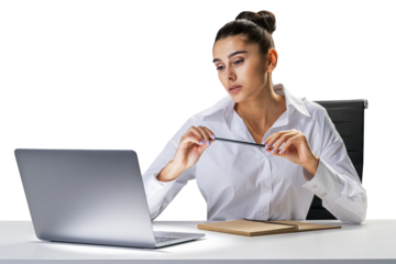 Thoughtful woman at office desk holding glasses, contemplating, with laptop and notebook