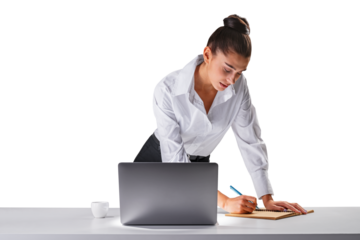 Concentrated young woman bending over desk writing, laptop beside, office work concept