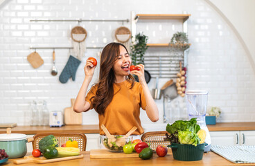 Portrait of beauty health asian woman having fun hold tomato cooking, vegan food healthy eat, fresh vegetable, Lycopene, vitamins, skincare, vegetarian in kitchen.Diet.Fitness, healthy food