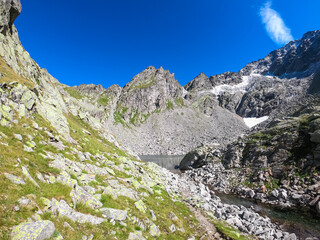 Alpine lake Grünecker See with panoramic view of majestic mountain peak Roemerspitz in High Tauern National Park, Carinthia, Austria. Idyllic hiking trail in Austrian Alps. Hike paradise Mallnitz