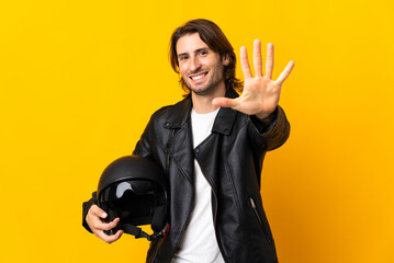 Man with a motorcycle helmet isolated on yellow background counting five with fingers
