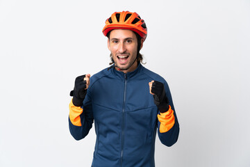 Young cyclist man isolated on white background celebrating a victory in winner position - obrazy, fototapety, plakaty