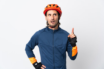 Young cyclist man isolated on white background thinking an idea pointing the finger up - obrazy, fototapety, plakaty