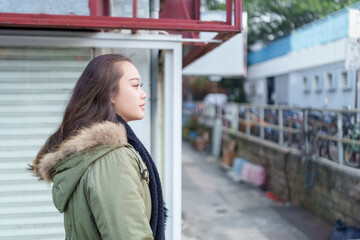 A woman in her 20s walking in the city of Hong Kong's New Territories...