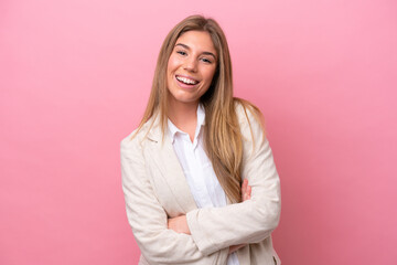 Young caucasian woman isolated on pink bakcground keeping the arms crossed in frontal position