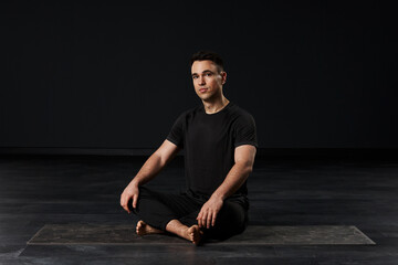 The lovely young man, cloaked in a dark ensemble, radiates a sense of tranquility and vitality...