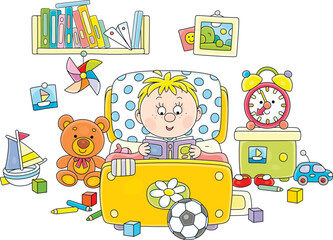 Funny little boy lying in his small bed and reading an interesting book with fairy tales among funny toys in a nursery room, vector cartoon illustration isolated on a white background