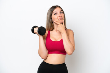 Young sport Rumanian woman making weightlifting isolated on white background having doubts