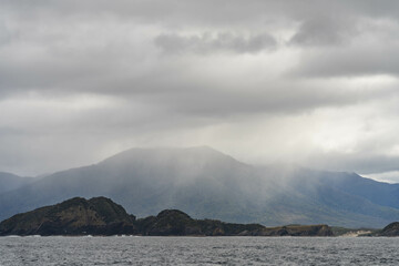 Yacht sailing on the horizon near the beach on the ocean ina  remote beautiful landscape, Tasmania, Australia and new zealand