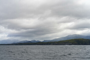 clouds over mountains over the water in a national park and beautiful rock mountain above the ocean in a national park