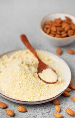Fresh almond flour in a  bowl and almonds