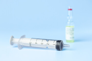 syringe for injectable medication on blue background