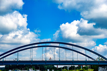 Bridge stretches over river under blue sky