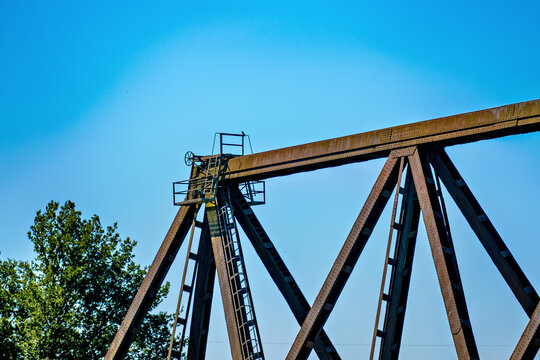 Old wooden railroad bridge against the blue sky - Powered by Adobe