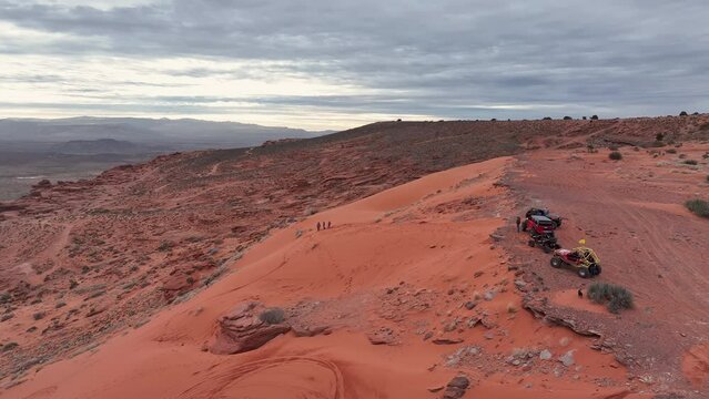 Aerial red rock sand cliff off road vehicle family play Utah. Southern Utah desert Sand Hollow. Red sandstone, dirt, sand trails. Outdoor extreme 4x4 recreation ride and adventure.