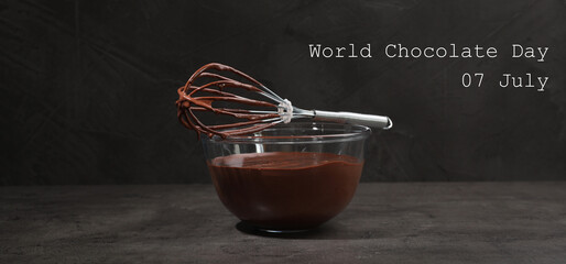 World Chocolate Day - July 7. Bowl and whisk with yummy chocolate cream on black table. Banner...