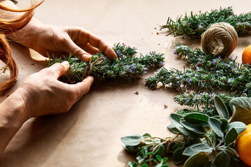 Herbal medicine. Woman's hands preparing blooming rosemary and others eco friendly medicinal herbs for drying. Herbalist preparing herbs for natural herbal methods of treatment. Alternative medicine.