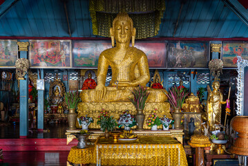 Golden wicker Buddha inside the main viharn of Wat Chong Klang, a famous landmark of Mae Hong Son town. The Buddhist temple and ceremonial hall are built in the Burmese style